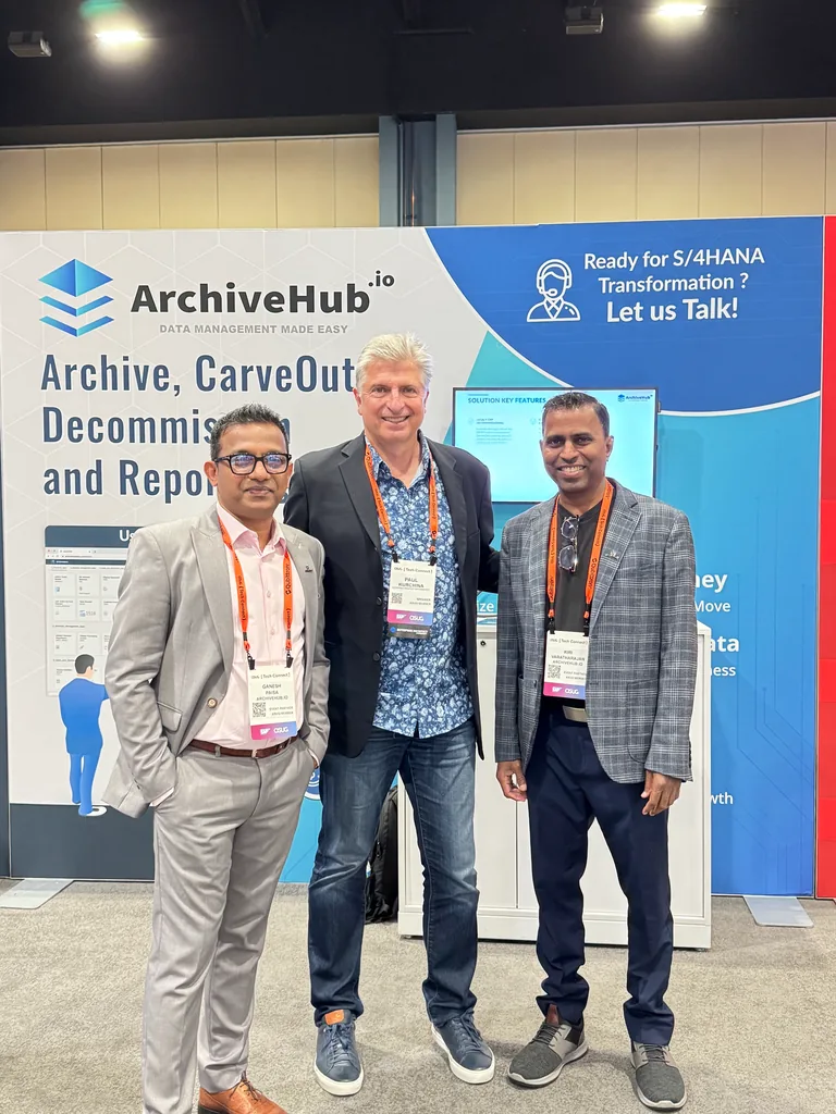 ArchiveHub team with a guest at its ASUG Tech Connect 2024 booth